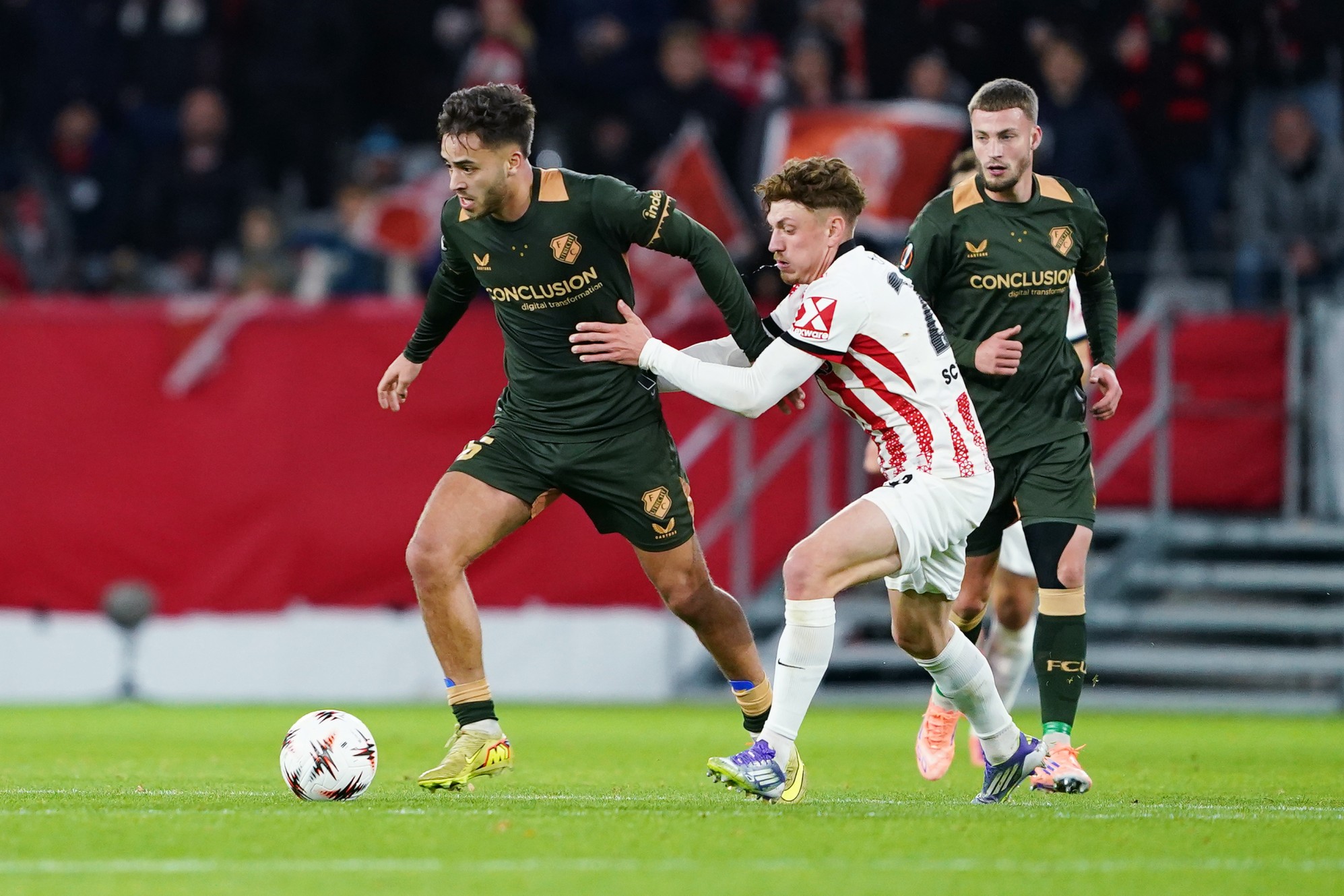 Souffian El Karouani of FC Utrecht is challenged by Philipp Treu of SC Freiburg