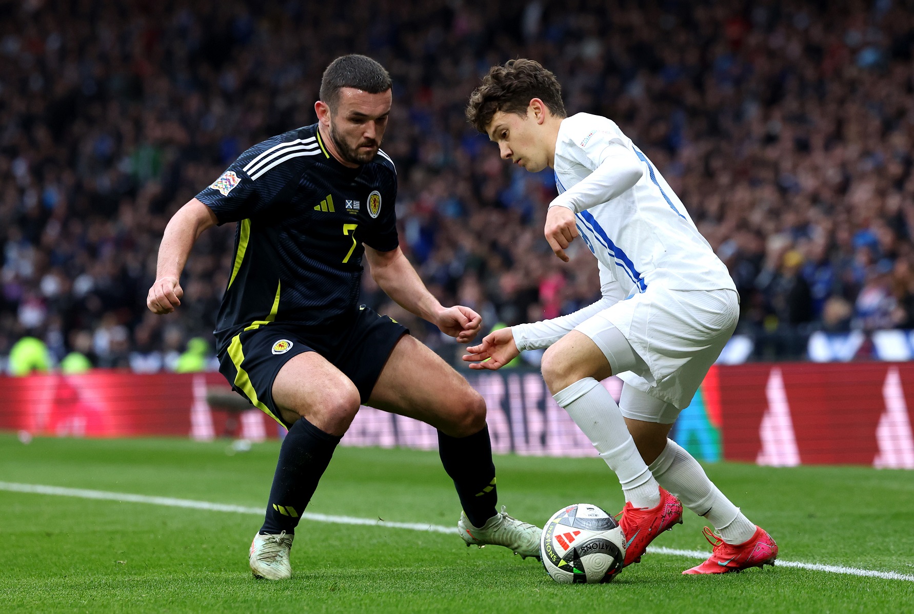 John McGinn of Scotland battles for possession with Konstantinos Karetsas of Greece