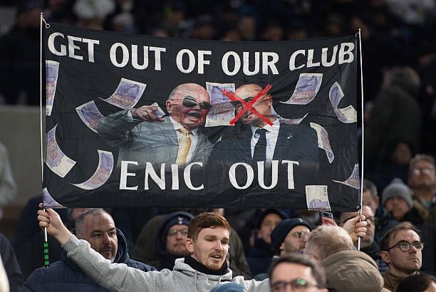 Tottenham fan holds up a banner protesting against the club's owners ENIC
