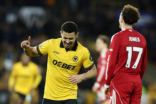 Wolves' Andre celebrates as Curtis Jones looks dejected