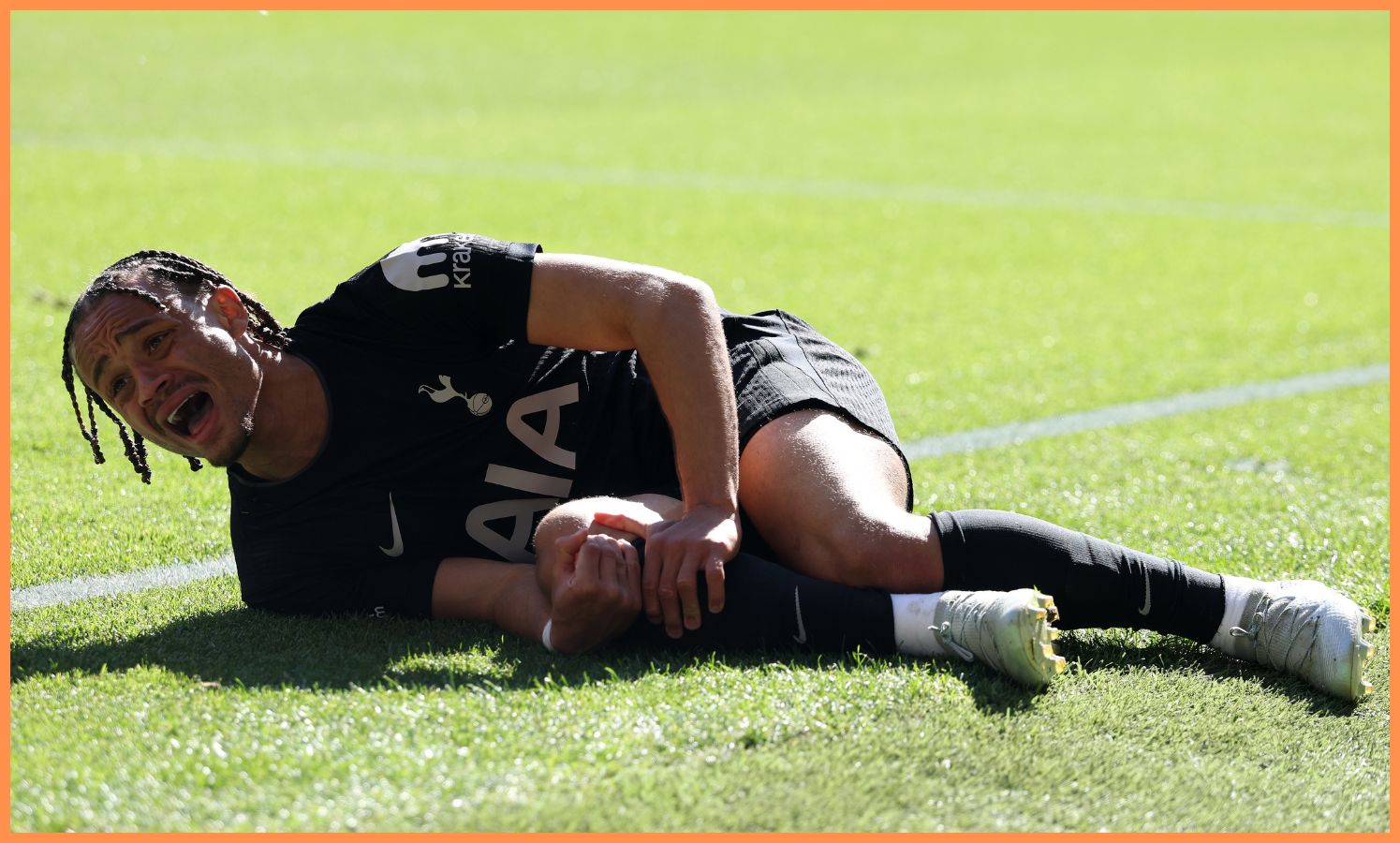 Xavi Simons reacts after getting injured during Wolves vs Tottenham