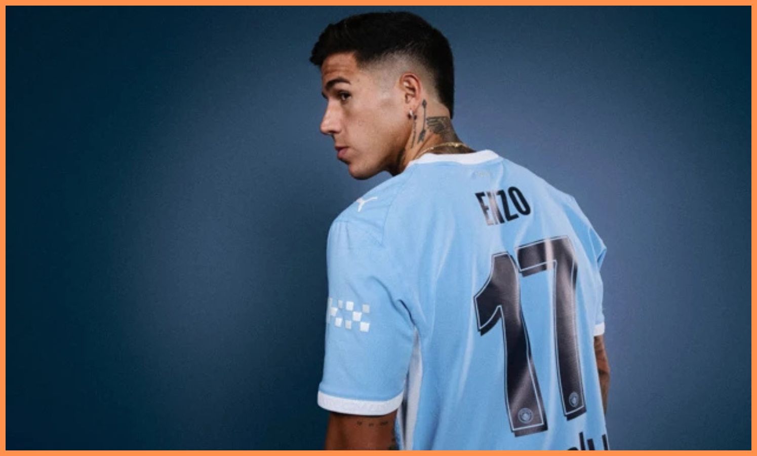 Enzo Fernandez posing in a Manchester City shirt
