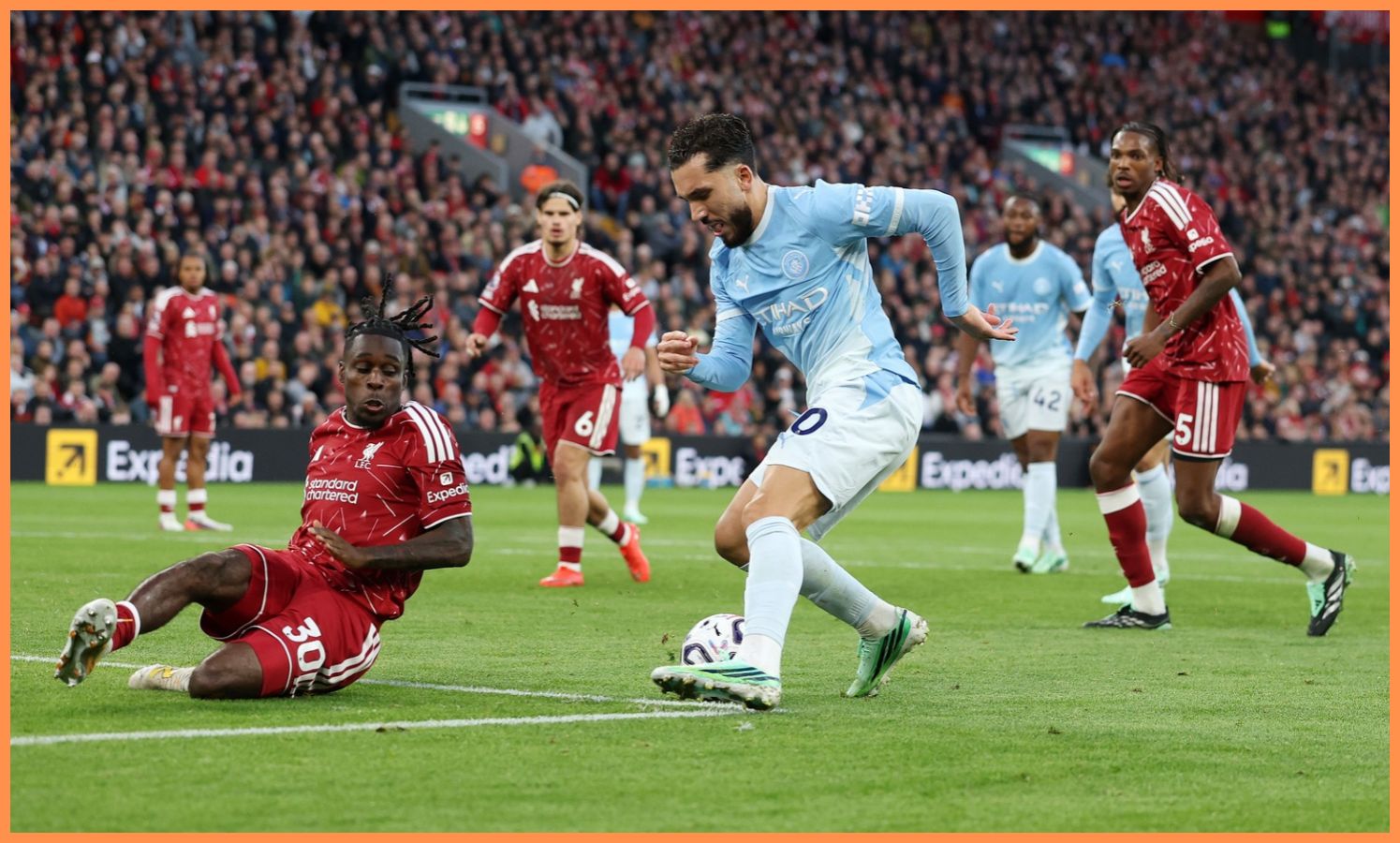 Rayan Cherki dribbles past Jeremie Frimpong