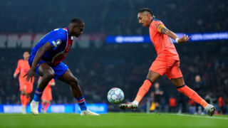Raphinha challenges Pacho. (Photo by Franco Arland/Getty Images)