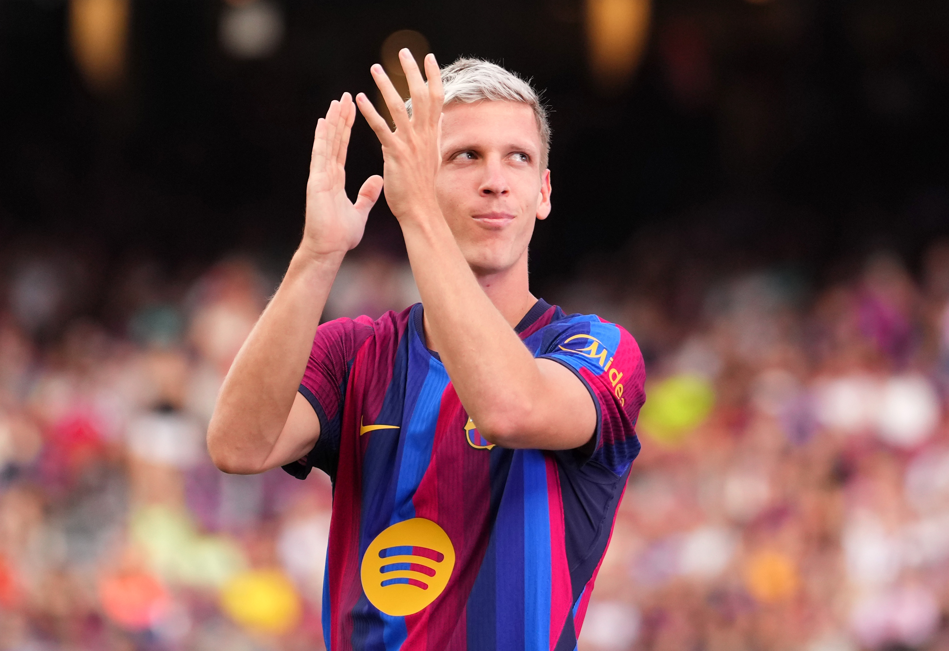Dani Olmo applauds the Barcelona fans