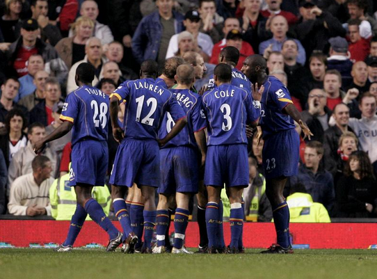 Arsenal players swarm around Mike Riley