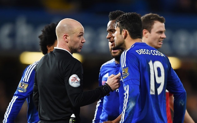 Chelsea players argue with referee Anthony Taylor
