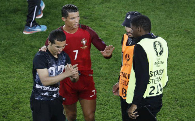 Cristiano Ronaldo takes selfie with fan on pitch during World Cup qualifier