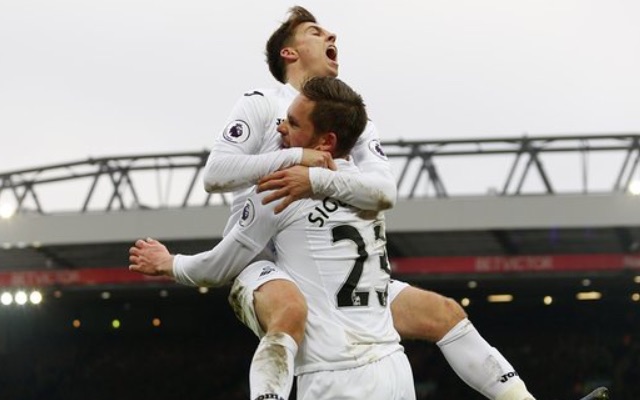 Gylfi Sigurdsson celebrates with Swansea teammate Tom Carroll at Liverpool