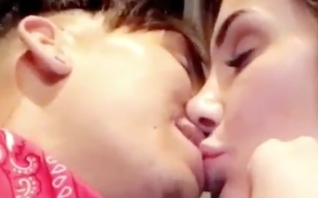 Roberto Firmino kissing wife Larissa Pereira at his 26th birthday party