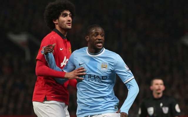 Marouane Fellaini and Yaya Toure in action during the Manchester derby