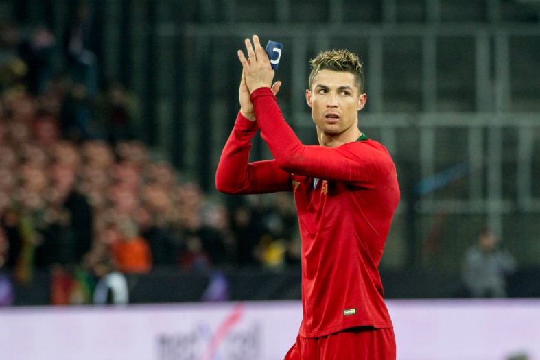 Cristiano Ronaldo of Juventus FC holds a jersey with the number