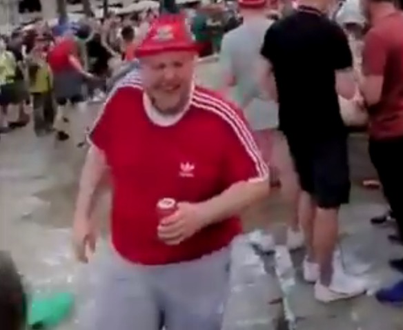 A large man wearing a red tee-shirt laughed before chanting Liverpool, taking the piss