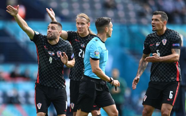 Croatia players complain after a penalty is given against Dejan Lovren (right)