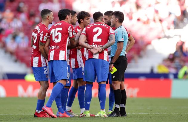 Atletico Madrid players and referee