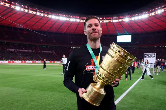 Xabi Alonso pictured holding the DFB-Pokal trophy following Bayer Leverkusen's final win over Kaiserslautern.