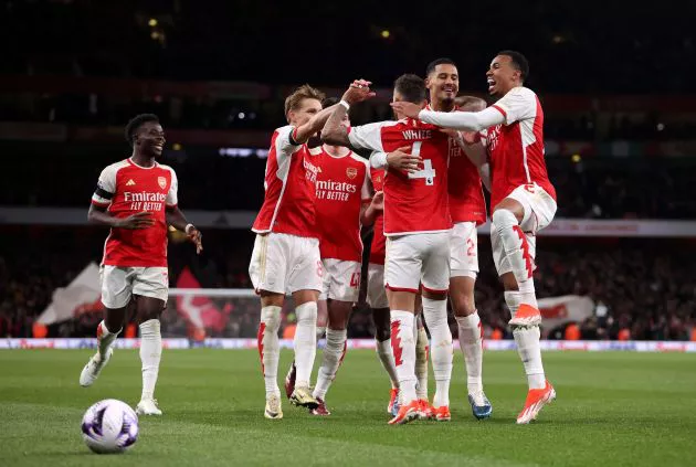 Arsenal players celebrating a goal during the Premier League match against Chelsea at Emirates Stadium on April 23, 2024.