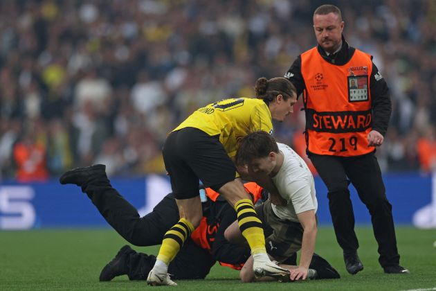 Borussia Dortmund midfielder Marcel Sabitzer pictured tackling a pitch invader at Wembley Stadium during the 2024 UEFA Champions League final
