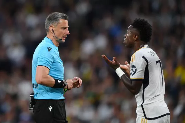 Real Madrid forward Vinicius Junior pictured (right) complaining to referee Slavko Vincic during the 2024 UEFA Champions League final