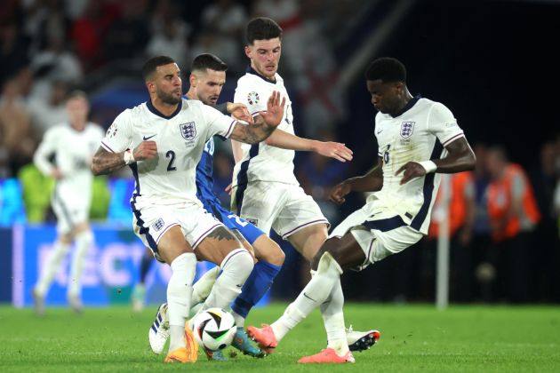 Petar Stojanovic of Slovenia challenges for the ball with Kyle Walker, Declan Rice and Marc Guehi of England during the UEFA EURO 2024 group stage match between England and Slovenia at Cologne Stadium on June 25, 2024 in Cologne, Germany.