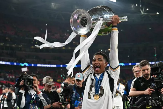 Real Madrid's English midfielder #5 Jude Bellingham celebrates with the trophy after winning the UEFA Champions League final football match between Borussia Dortmund and Real Madrid, at Wembley stadium, in London, on June 1, 2024.