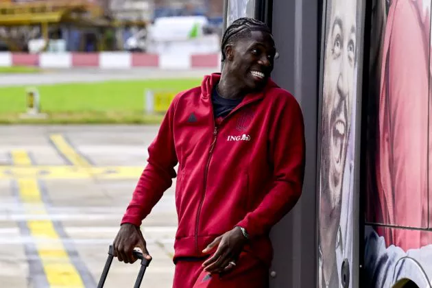 Belgium's midfielder Amadou Onana boards an aircraft with teammates at Brussels International Airport, Zaventem on June 12, 2024, as the Belgian national football team travel to Germany for the Euro 2024 European football Championships where they will play in Group F.