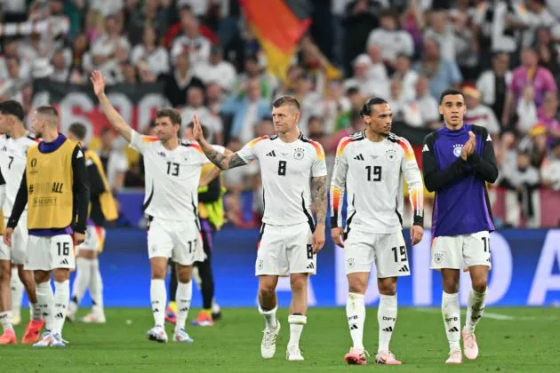 Germany's midfielder #08 Toni Kroos, Germany's midfielder #19 Leroy Sane and Germany's midfielder #10 Jamal Musiala (R) celebrate after winning the UEFA Euro 2024 Group A football match between Germany and Scotland at the Munich Football Arena in Munich on June 14, 2024.