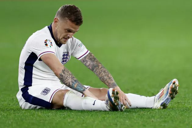 Kieran Trippier sits on the grass after sustaining an injury during the UEFA Euro 2024 Group C football match between Serbia and England at the Arena AufSchalke in Gelsenkirchen on June 16, 2024.