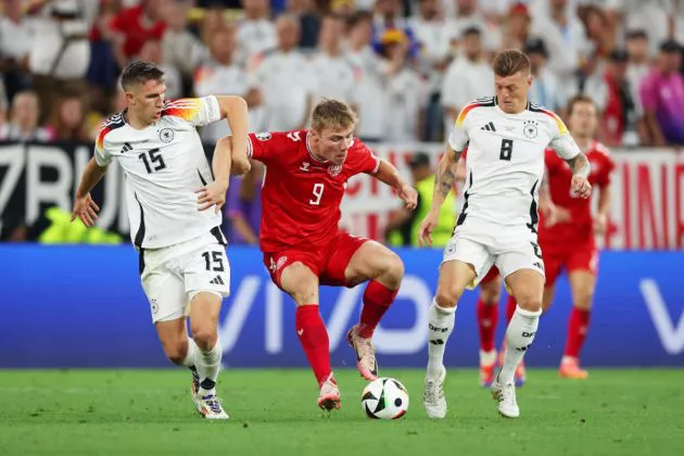 Rasmus Hojlund of Denmark is challenged by Nico Schlotterbeck and Toni Kroos of Germany during the UEFA EURO 2024 round of 16 match between Germany and Denmark at Football Stadium Dortmund on June 29, 2024 in Dortmund, Germany.