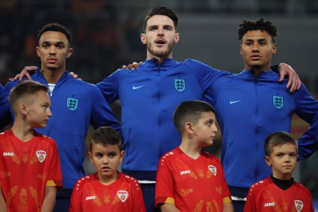 Trent Alexander-Arnold, Declan Rice and Ollie Watkins of England sing their national anthem prior to the UEFA EURO 2024 European qualifier match between North Macedonia and England at National Arena Todor Proeski on November 20, 2023