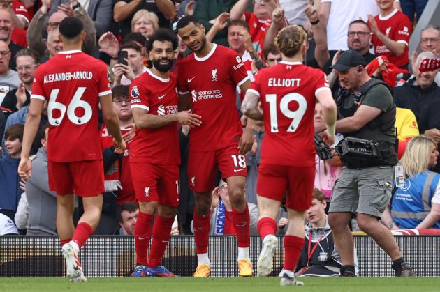 Liverpool's Dutch striker #18 Cody Gakpo (C) celebrates scoring the team's third goal with Liverpool's Egyptian striker #11 Mohamed Salah (2L) during the English Premier League football match between Liverpool and Tottenham Hotspur at Anfield in Liverpool, north west England on May 5, 2024.