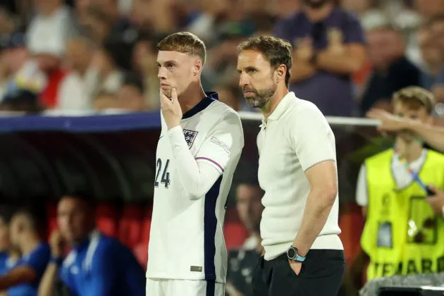 Cole Palmer of England looks on as he prepares to come on as a substitute as Gareth Southgate, Head Coach of England, looks on during the UEFA EURO 2024 group stage match between England and Slovenia at Cologne Stadium on June 25, 2024