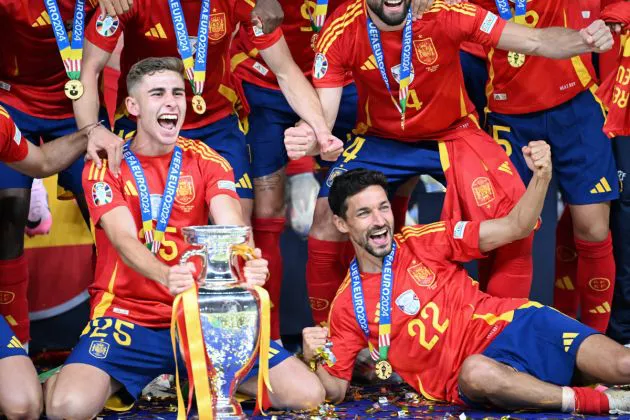 Spain's forward #25 Fermin Lopez, Spain's forward #22 Jesus Navas along with teammates celebrate with the trophy after winning the UEFA Euro 2024 final football match between Spain and England at the Olympiastadion in Berlin on July 14, 2024.