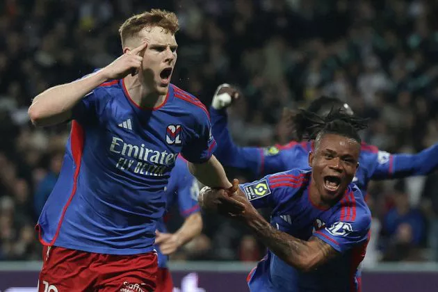 Lyon's Irish defender #12 Jake O'Brien (L) celebrates after scoring Lyon's third goal during the French L1 football match between Toulouse FC and Olympique Lyonnais (OL) at The TFC Stadium in Toulouse, southwestern France, on March 15, 2024.