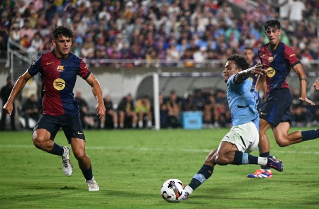 Oscar Bobb (2R) kicks the ball during the 2024 FC Series pre-season friendly football match between FC Barcelona and Manchester City at Camping World Stadium in Orlando, Florida, on July 30, 2024.