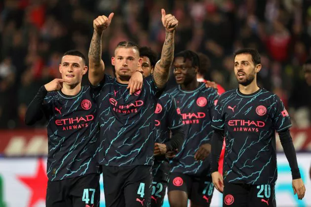 Kalvin Phillips of Manchester City celebrates with teammate Phil Foden after scoring their team's third goal during the UEFA Champions League match between FK Crvena zvezda and Manchester City at Stadion Rajko Miti? on December 13, 2023