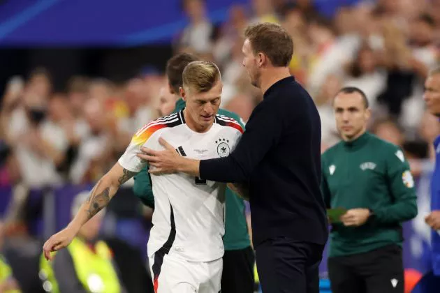 Toni Kroos of Germany is embraced by Julian Nagelsmann, Head Coach of Germany, after being substituted during the UEFA EURO 2024 group stage match between Germany and Scotland at Munich Football Arena on June 14, 2024 in Munich, Germany.