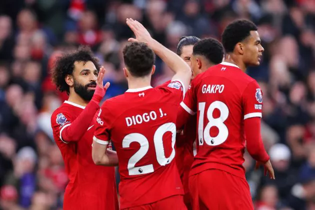 Mohamed Salah of Liverpool celebrates with teammate Diogo Jota after scoring the team's first goal during the Premier League match between Liverpool FC and Brentford FC at Anfield on November 12, 2023 in Liverpool, England.