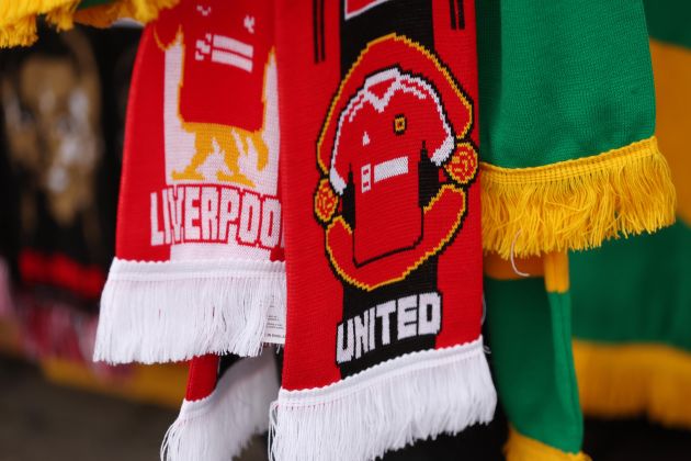 A photo showing a Liverpool scarf next to two Man United scarves