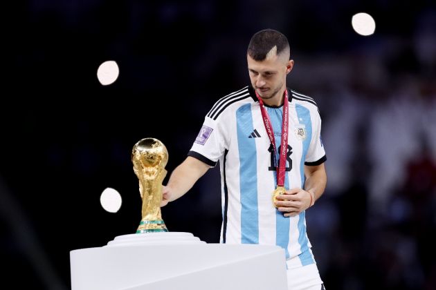 Guido Rodriguez of Argentina touches the FIFA World Cup Qatar 2022 Winner's Trophy as he walks past during the awards ceremony after the FIFA World Cup Qatar 2022 Final match between Argentina and France at Lusail Stadium on December 18, 2022 in Lusail City, Qatar.