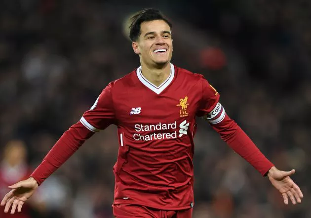 Liverpool's Brazilian midfielder Philippe Coutinho celebrates scoring the opening goal of the English Premier League football match between Liverpool and Swansea City at Anfield in Liverpool, north west England on December 26, 2017.