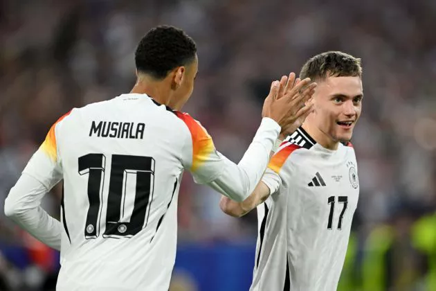 Florian Wirtz of Germany celebrates scoring his team's first goal with teammate Jamal Musiala during the UEFA EURO 2024 group stage match between Germany and Scotland at Munich Football Arena on June 14, 2024 in Munich, Germany.