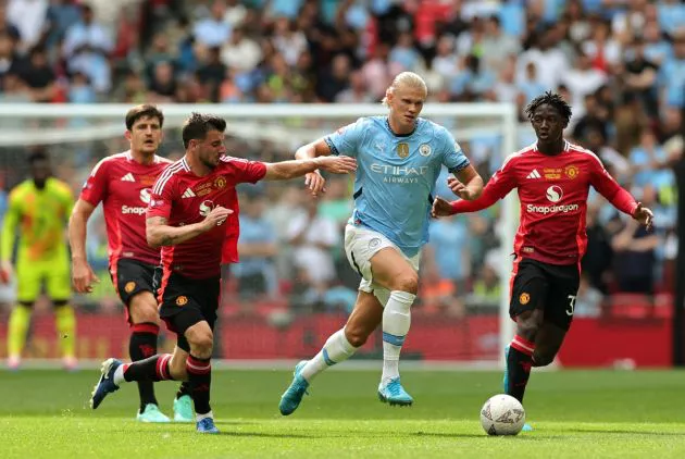 Erling Haaland of Manchester City is challenged by Mason Mount and Kobbie Mainoo of Manchester United during the 2024 FA Community Shield match between Manchester United and Manchester City at Wembley Stadium on August 10, 2024 in London, England.