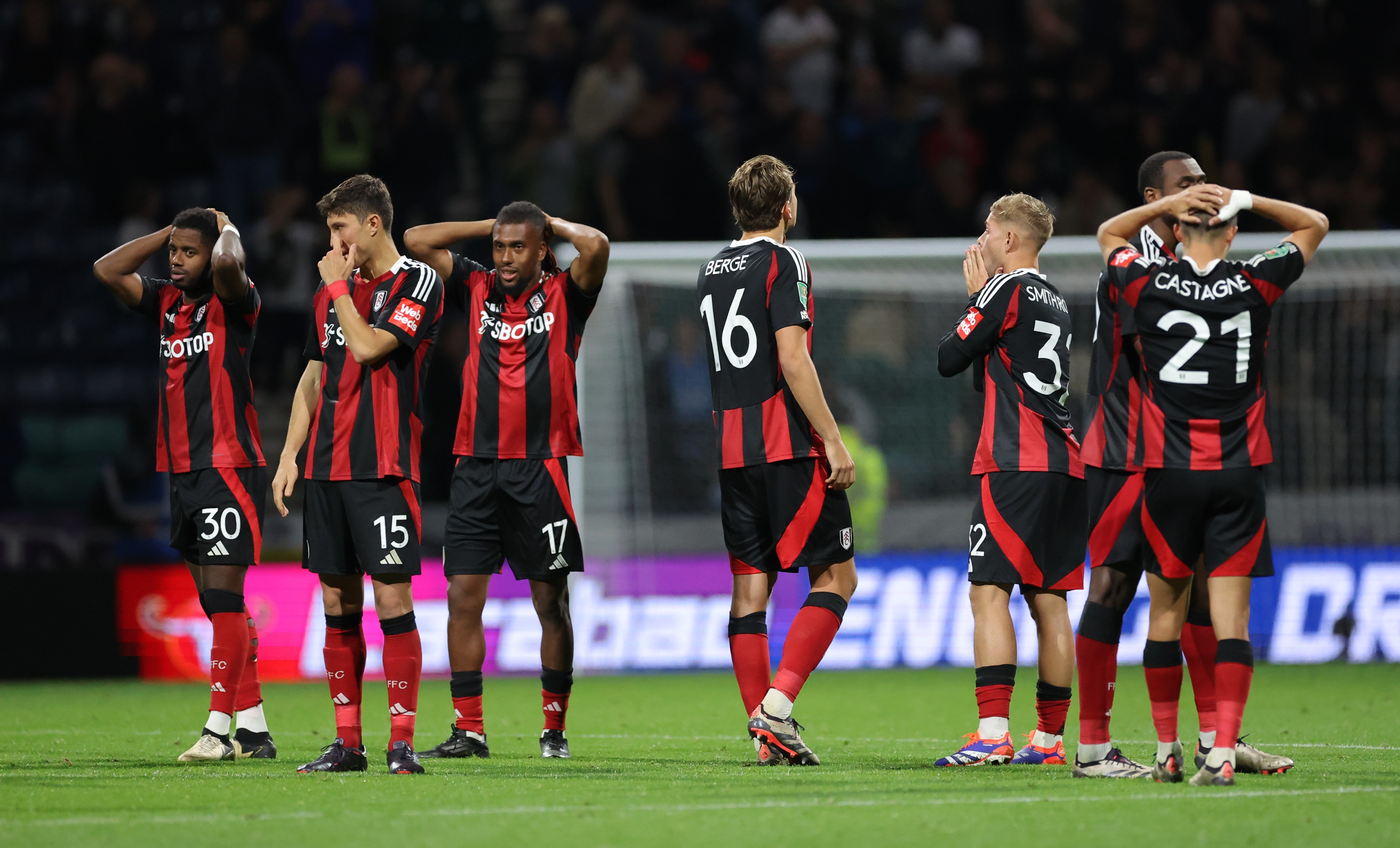 Fulham players are crestfallen after losing an historic League Cup penalty shoot-out to Preston North End (Photo by Alex Livesey/Getty Images)