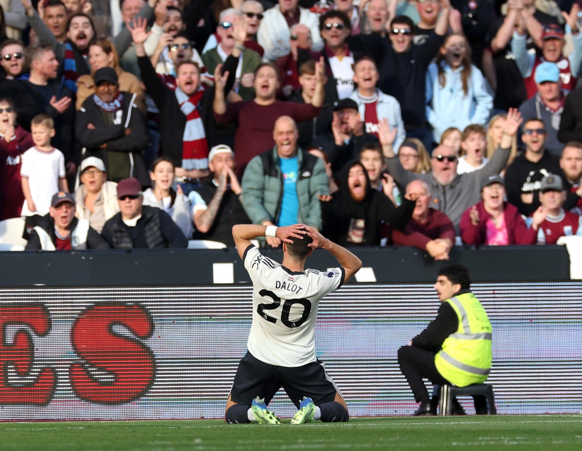 Diogo Dalot reacts after his miss against West Ham