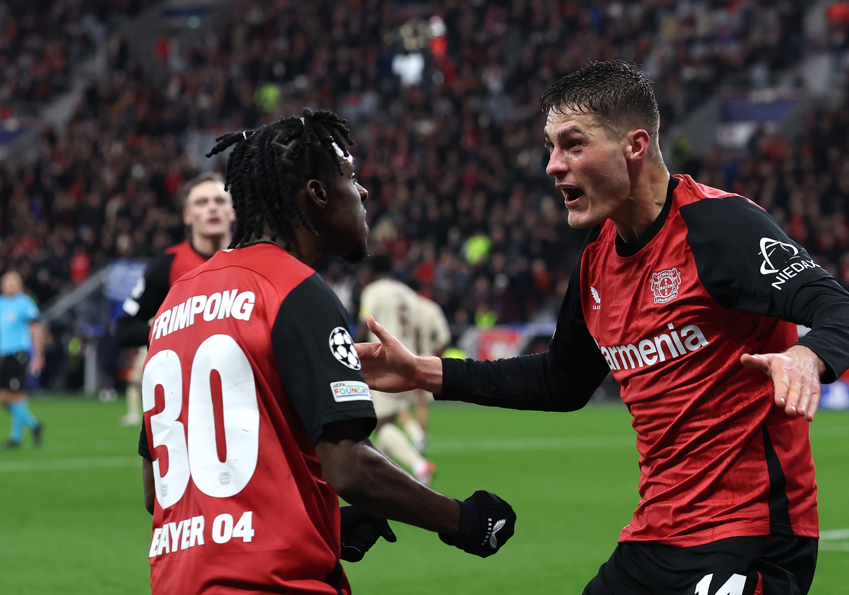 Liverpool target Jeremie Frimpong celebrates with Leverkusen teammate Patrik Schick.