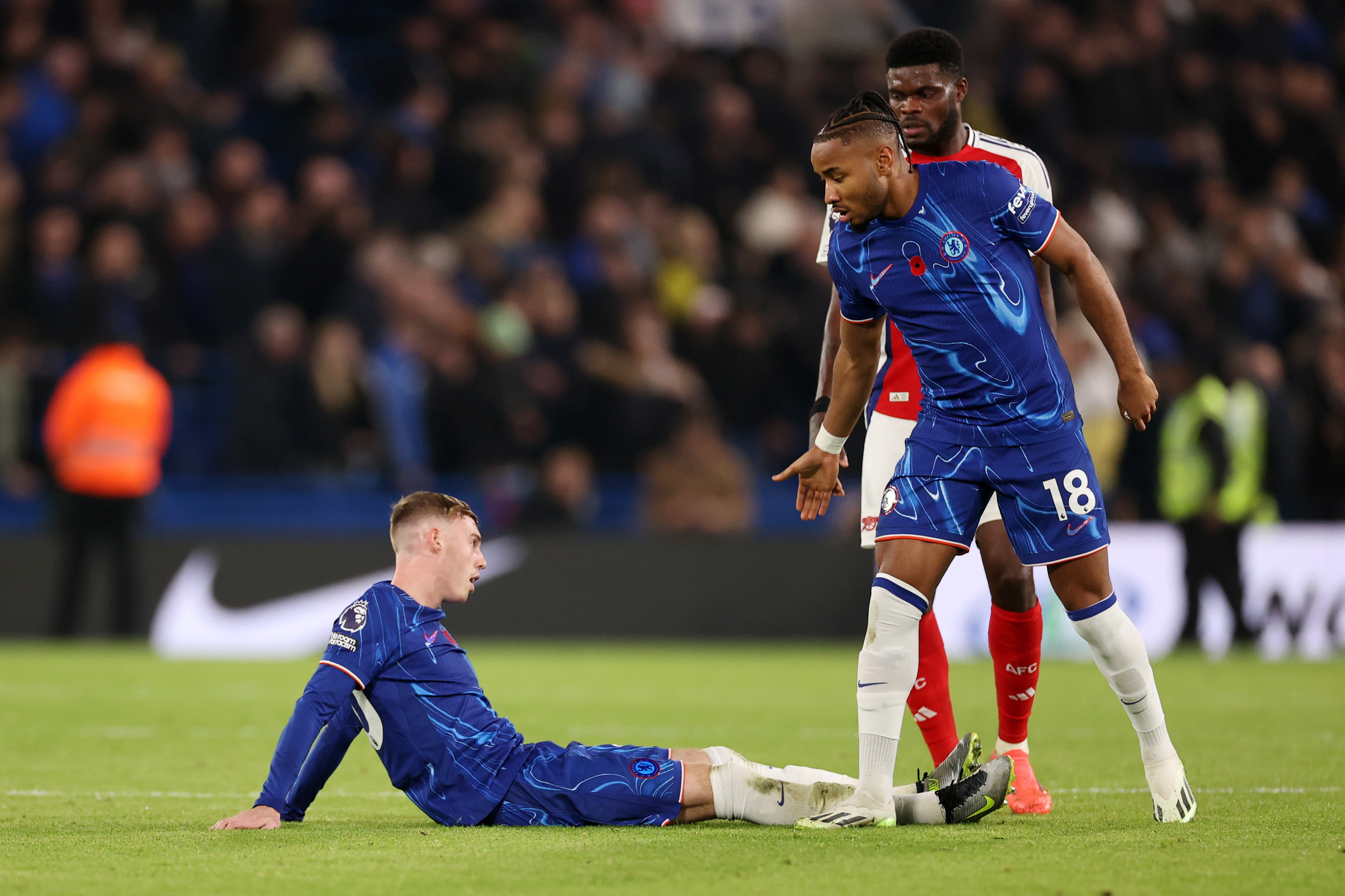 Cole Palmer of Chelsea reacts alongside team mate Christopher Nkunku