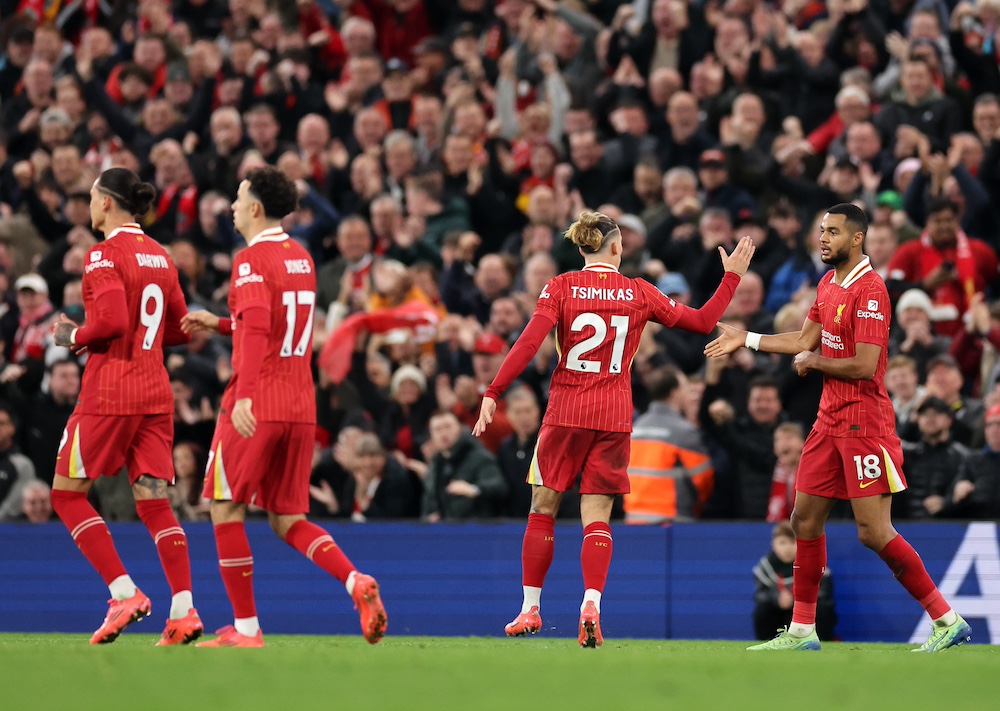 Cody Gakpo celebrates scoring an equaliser for Liverpool against Brighton with teammates.