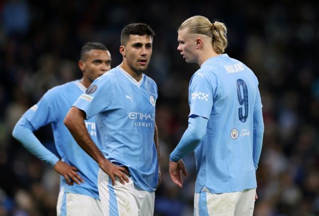 Erling Haaland (right) in action for Man City.