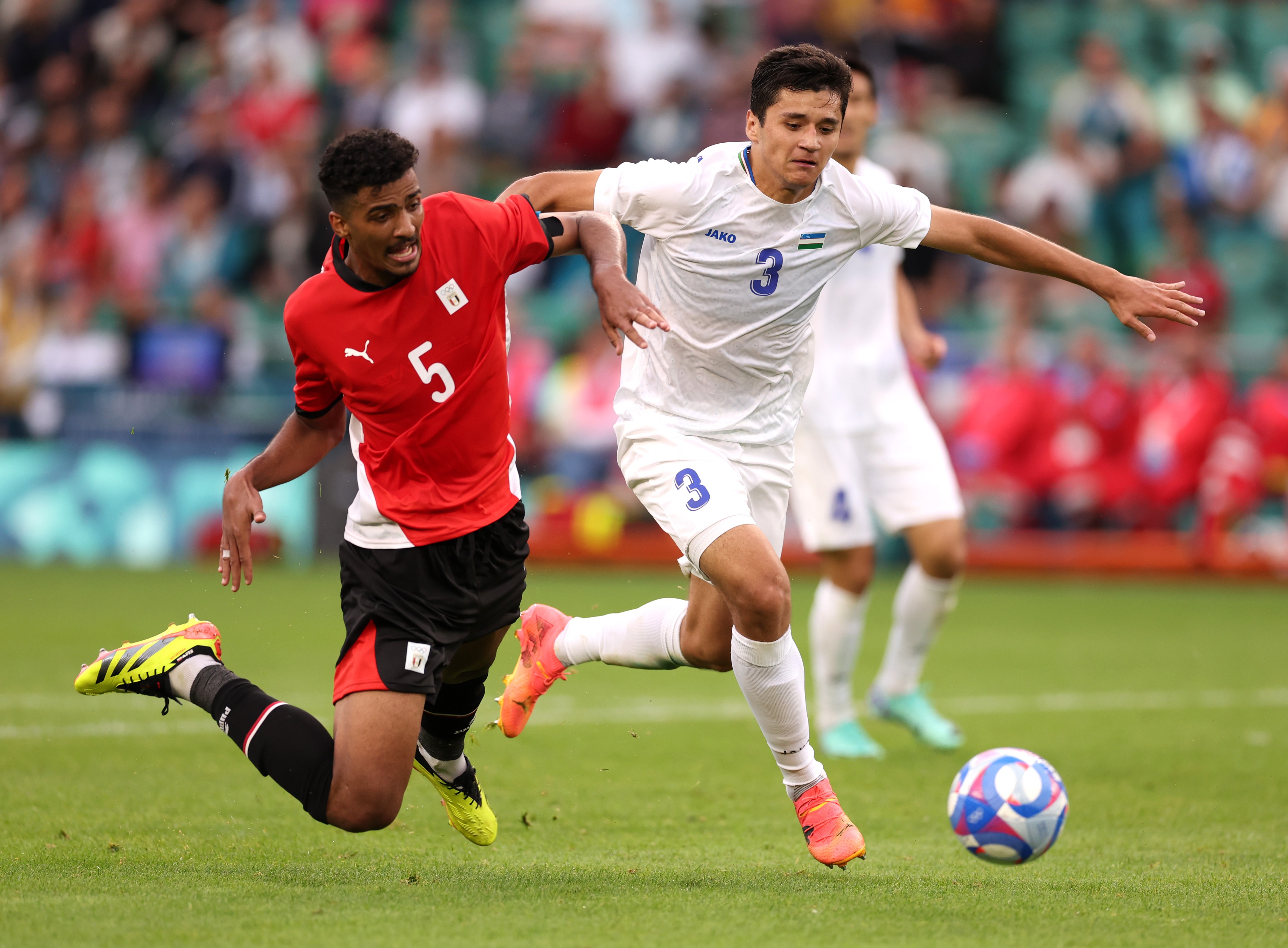 Abdukodir Khusanov is challenged by Hossam Abdelmaguid